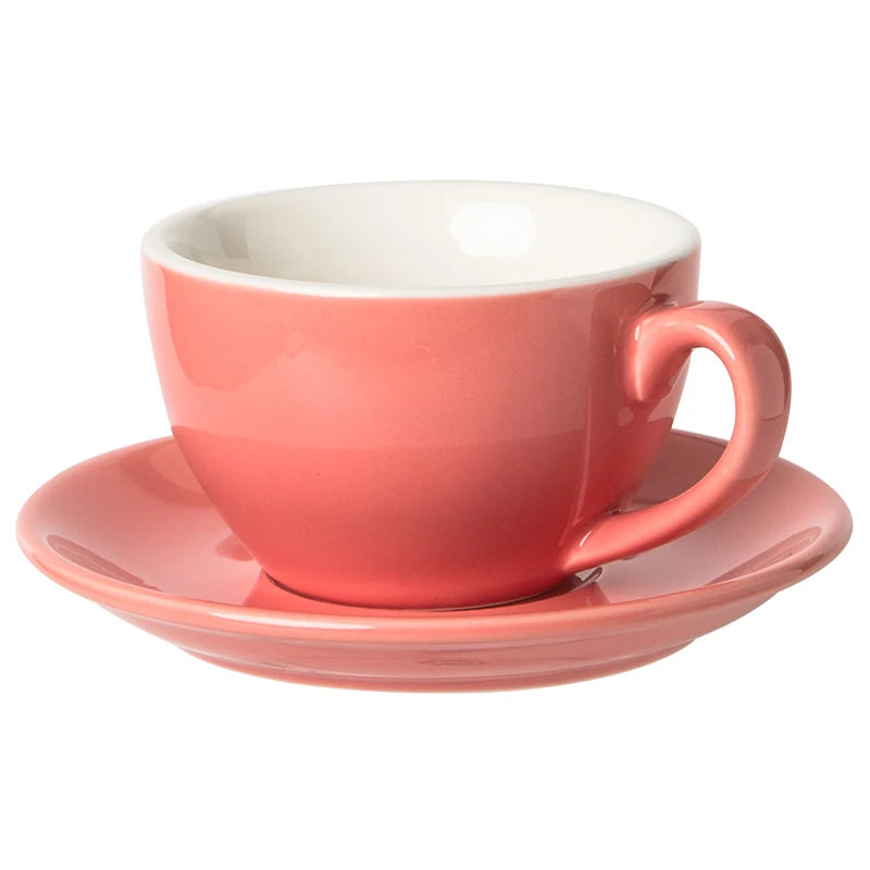A coral pink ceramic coffee cup with a matching saucer and a white interior, shown on a plain white background.